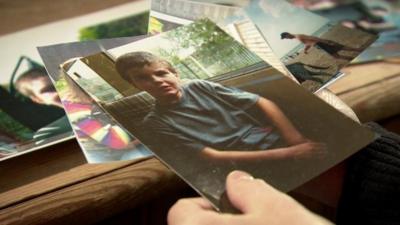 Close up of hands of campaigner Lynne McCarrick holding a photograph of her son, Chris