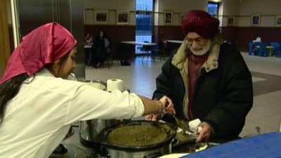 Woman serving food in a Sikh temple