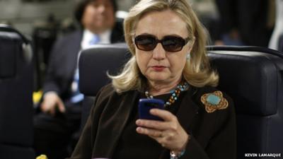 File photo from 2011 of then Secretary of State Hillary Clinton using her Blackberry