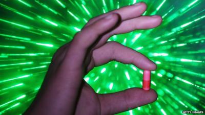 A youth holds a "Legal High" chemical pill on February 26, 2015 in Manchester, England. There has been a significant rise in the use of Legal Highs that are actually not against the law.