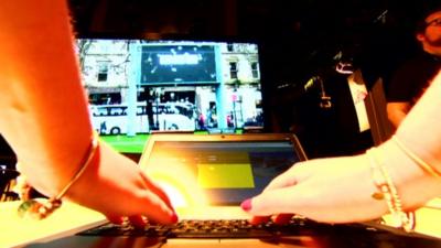 Hands typing at a computer keyboard