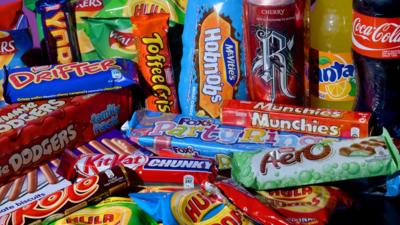 Photo of biscuits, crisps, chocolate bars and carbonated drinks