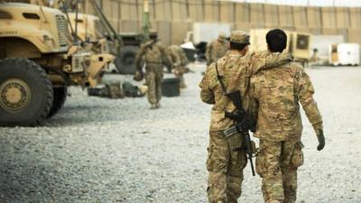 A US soldier from the 3rd Cavalry Regiment walking with the unit's Afghan interpreter