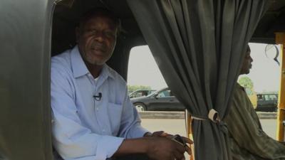 Abdulahi Kaura Abubakar in a vehicle about to cross the bridge over the Kaduna river in Nigeria