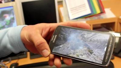 Jean Sebastien Beaud shows the BBC a photo of the crash site