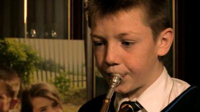 School pupil playing trumpet