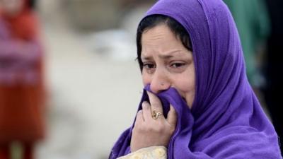 A resident looks on as waters rise in a neighbourhood of Srinagar