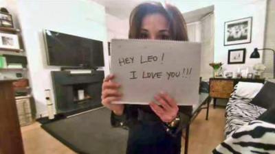 Paula holding a sign