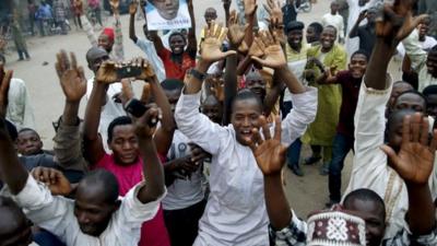 Supporters of the presidential candidate Muhammadu Buhari and his All Progressive Congress party celebrate in Kano