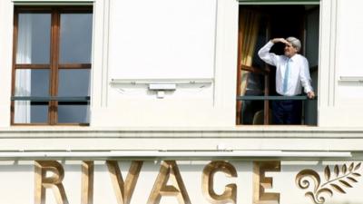 U.S. Secretary of State John Kerry looks out of his room at the Beau Rivage Palace Hotel during a break during the Iran nuclear program talks in Lausanne