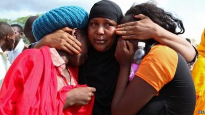 Some of the Garissa University students who were rescued, comfort each other at the Garissa military camp, in Garissa town