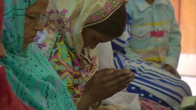 Close up of Pakistani Christian woman praying in a Lahore church