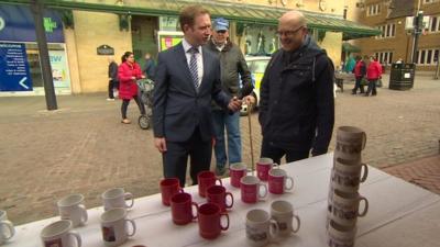 Adam Fleming with mug stall in Northampton