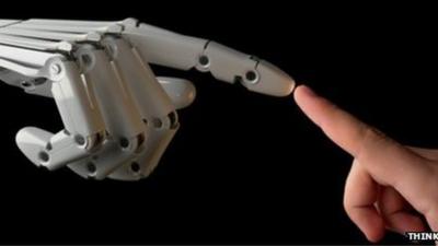 A robot finger touches a human one