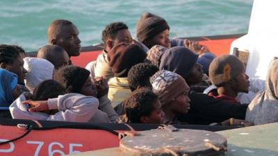 Migrants on a coast guard dinghy boat arrive at the Sicilian Porto Empedocle harbour