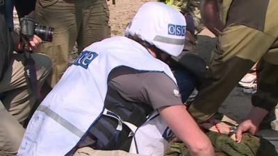 An observer helps an injured reporter