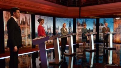 The five party leaders standing at their podiums