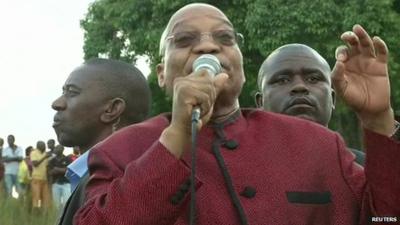 South African president Jacob Zuma addressing foreigners waiting in a camp after fleeing violence