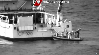 Rescuers take part in an operation off the coast of Sicily