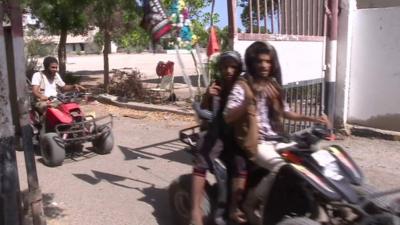 Men on quad bikes