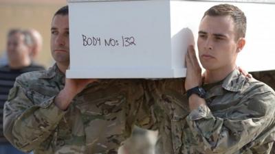 Maltese soldiers carry a coffin