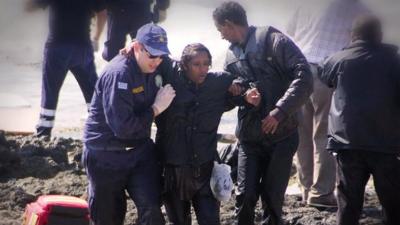 Migrant woman being rescued