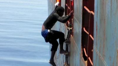 Migrant climbs on to ship