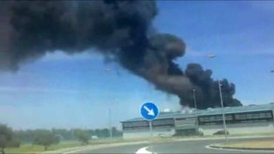 Black smoke billowing from crash scene