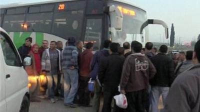 Palestinians getting on bus - library image