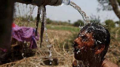 An Indian man takes bath