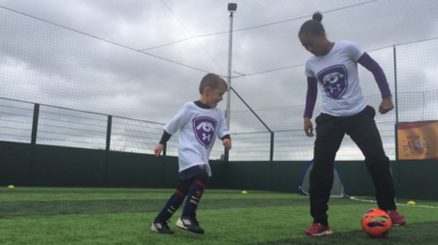 Rachel Yankey and young boy during a Footy Pups session at the FA People's Cup Final.