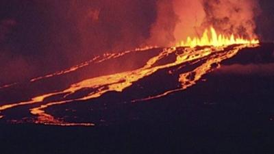 The Wolf volcano spews smoke and lava on Isabela Island