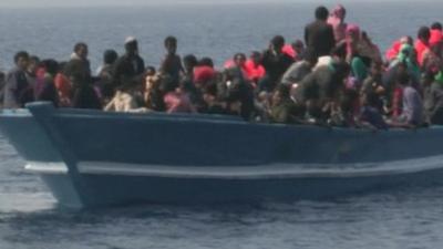 Migrants on wooden vessel