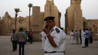 Egyptian security officials stand guard at the Karnak Temple in Luxor