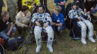 Russian cosmonaut Anton Shkaplerov and European Space Agency astronaut Samantha Cristoforetti rest after landing