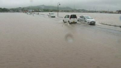 Cars driving through flood water