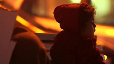 Partially silhouetted image of a young child migrant on the Greek island of Lesbos