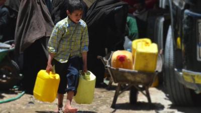 Yemeni boy carrying water