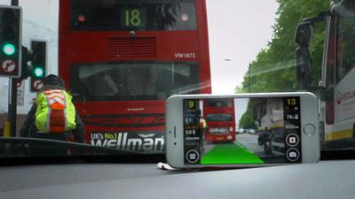 A smartphone by a car windscreen