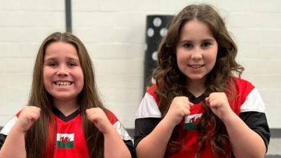 Lili-Rose and Annarose pose for a photo in their Team Wales tracksuits 