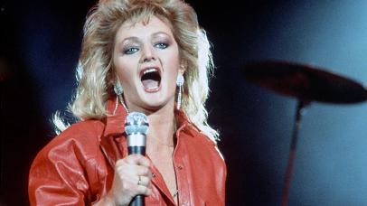 Singing Bonnie Tyler wearing a red leather jumpsuit