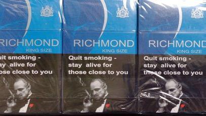 Packets of blue Richmond cigarettes, along with a picture of Marlon Brando smoking during a scene in the Godfather.