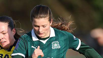 Plymouth Argyle striker Tianna Teisar competing for the ball with Oxford United defender Grace Palmer