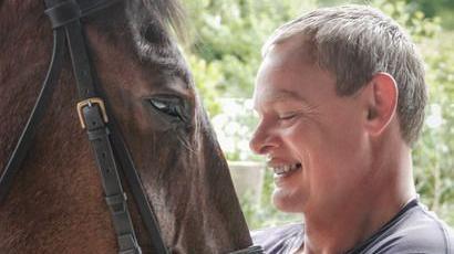 Martin Clunes smiling at his horse Chester