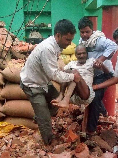 A man is carried from the debris of his damaged home following a major dust storm in Etmadpur, in Agra district in northern India"s Uttar Pradesh state, on May 3, 2018.