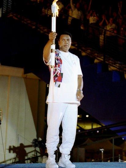 Muhammad Ali holds the torch before lighting the Olympic Flame during the Opening Ceremony of the 1996 Centennial Olympic Games in Atlanta, Georgia