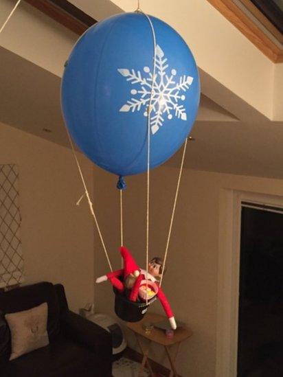 elf-attached-to-a-big-balloon.