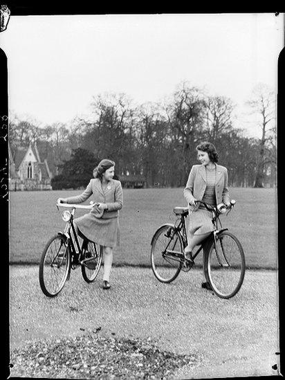 Princess Margaret Rose (1930 - 2002) and Princess Elizabeth (right) preparing to set out on bicycles in the grounds of the Royal Lodge, Windsor, Berkshire