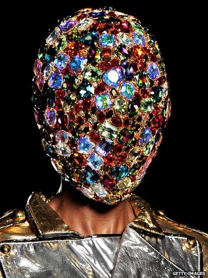 Model wearing jewelled head piece.