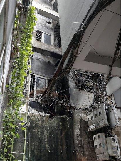 The back of an apartment block after a fire erupted in Hanoi, Vietnam, 13 September 2023.